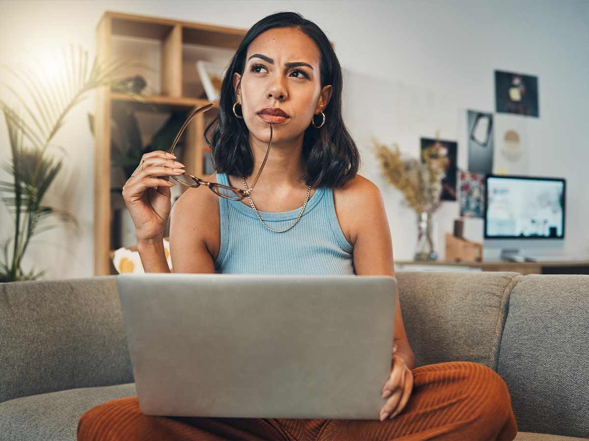 Illuminate Counselling North Vancouver, BC woman sitting on sofa with laptop
