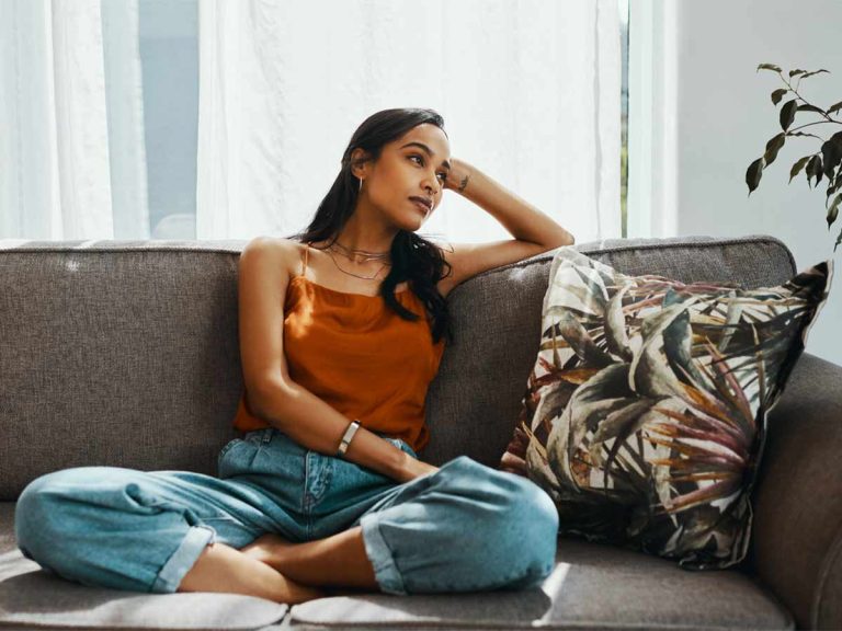 Illuminate Counselling North Vancouver, BC woman sitting on sofa smiling