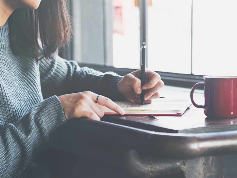 Illuminate Counselling North Vancouver, BC Woman writing in journal