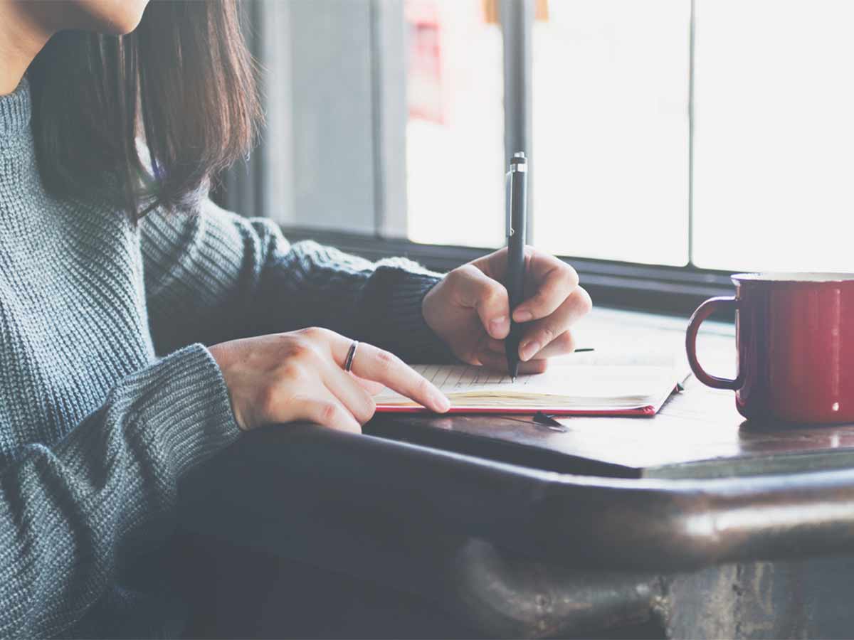 Illuminate Counselling North Vancouver, BC Woman writing in journal